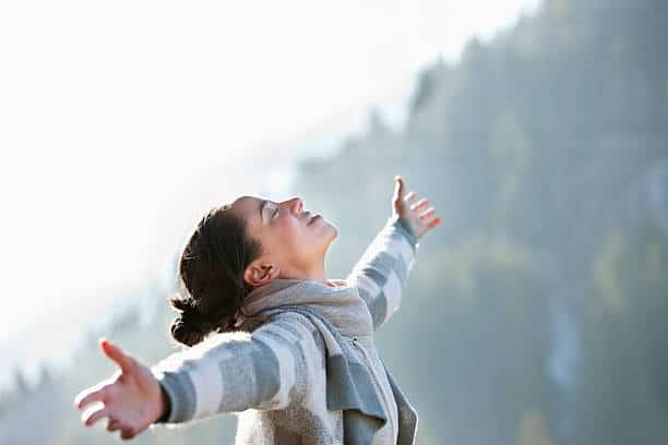 A woman who has gained freedom with her hands raised.