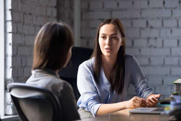 Legal Assistance Serious professional female advisor consulting client at meeting talking having legal assistance concept.