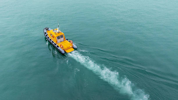Maritime Laws Orange rescue or coast guard patrol boat, patrolling. Police motor boat