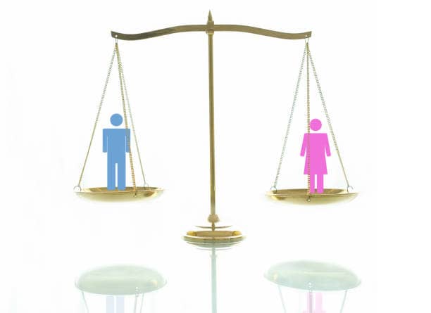 The Gender Pay Gap in Medical Law 1 Equality concept. Women and men on beams scales on a white background.