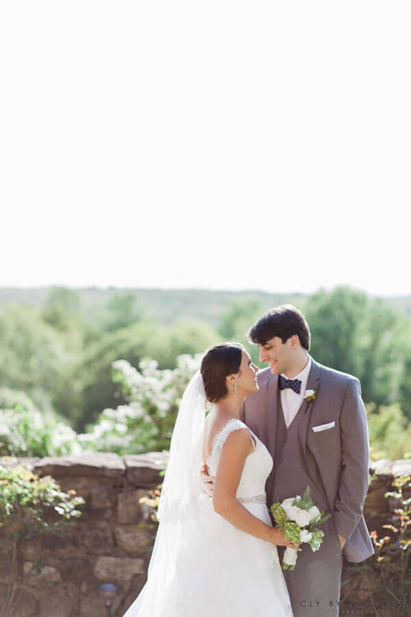 Bride and groom sharing romantic outdoor wedding moment at Le Chateau Banquets
