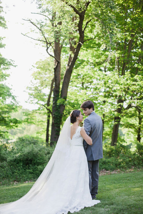 Bride and groom sharing a romantic moment in the venue’s lush garden setting.