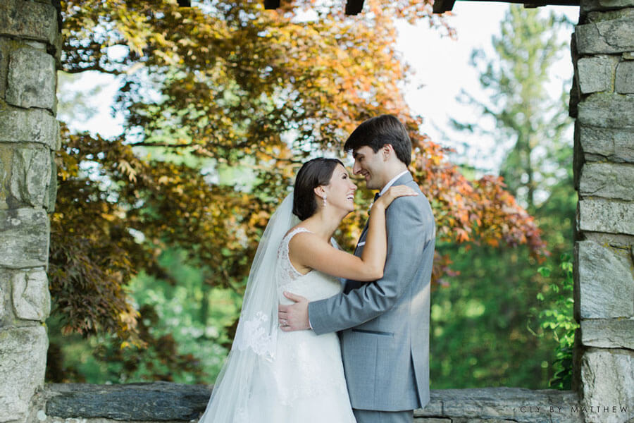 Bride and groom sharing a romantic moment in the venue's garden pavilion.