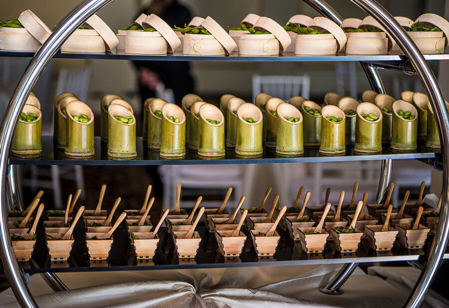 Asian station display featuring elegantly served appetizers in bamboo presentation vessels.