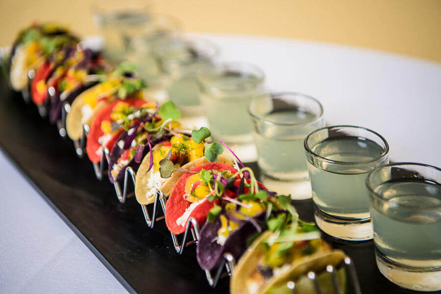 Mini grilled cod tacos with mango salsa and margarita shooters for cocktail hour catering.