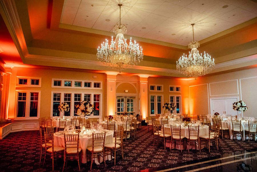 Elegant banquet hall with crystal chandeliers and formal event table settings.