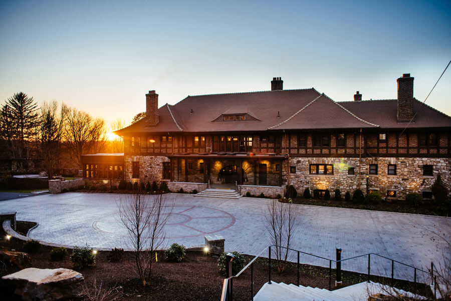 Exterior view of Le Chateau South Salem wedding venue at sunset