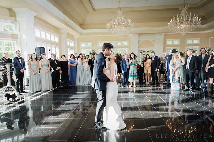 Bride and groom sharing their first dance in a grand ballroom at Le Chateau Banquets