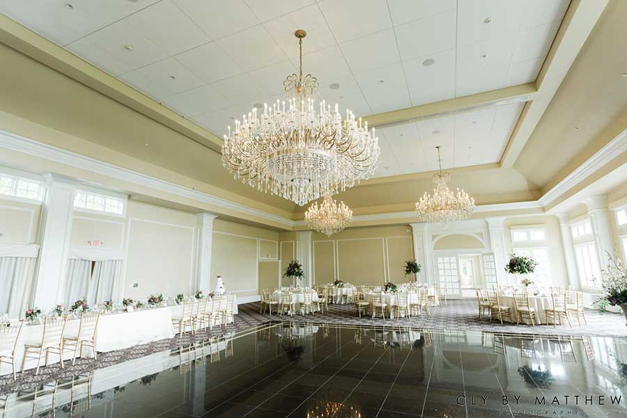 Elegant ballroom with crystal chandeliers and spacious dance floor at Le Chateau Banquets