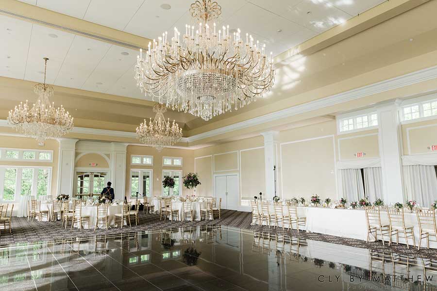 Elegant ballroom reception venue with crystal chandeliers and spacious dance floor.