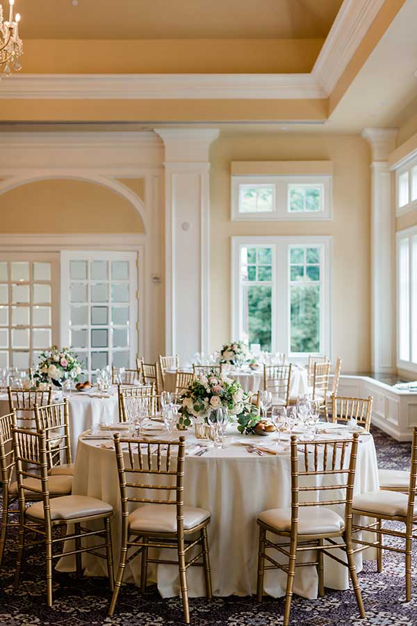 Elegant banquet hall with beautifully set tables for a wedding reception at Le Chateau Banquets