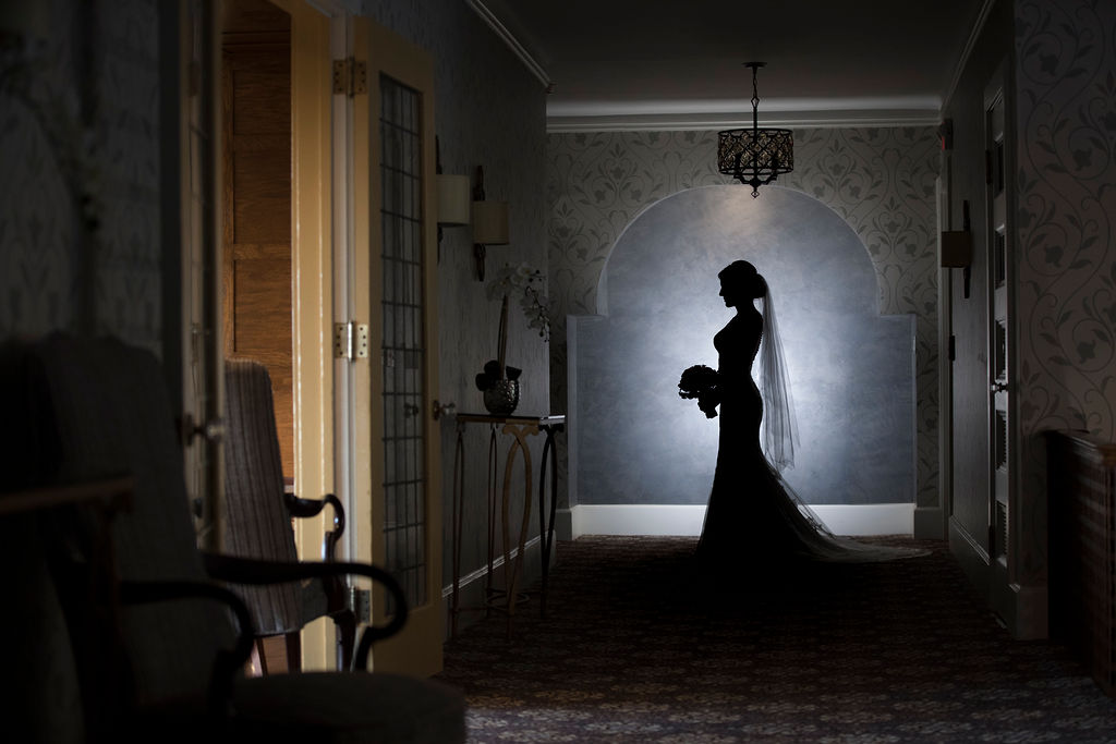 Silhouette of bride in elegant hallway at Le Chateau wedding venue