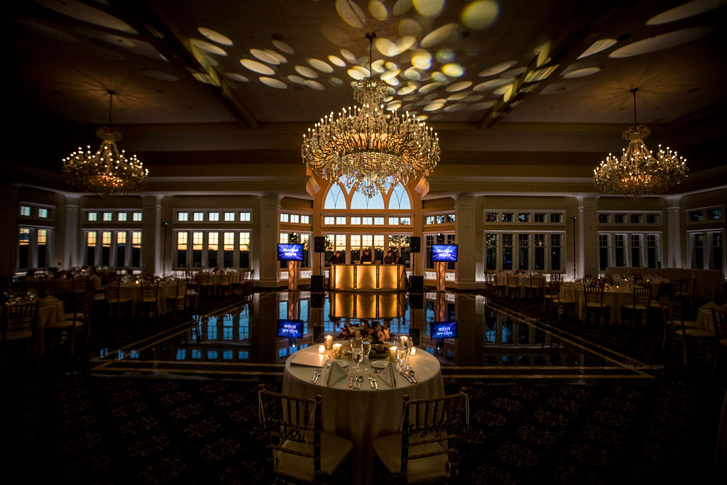 Grand ballroom reception with crystal chandeliers and an elegant dance floor.