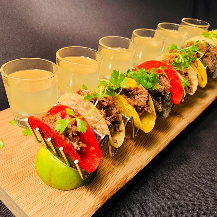 Mini braised short rib tacos with margarita shooters for cocktail hour catering.
