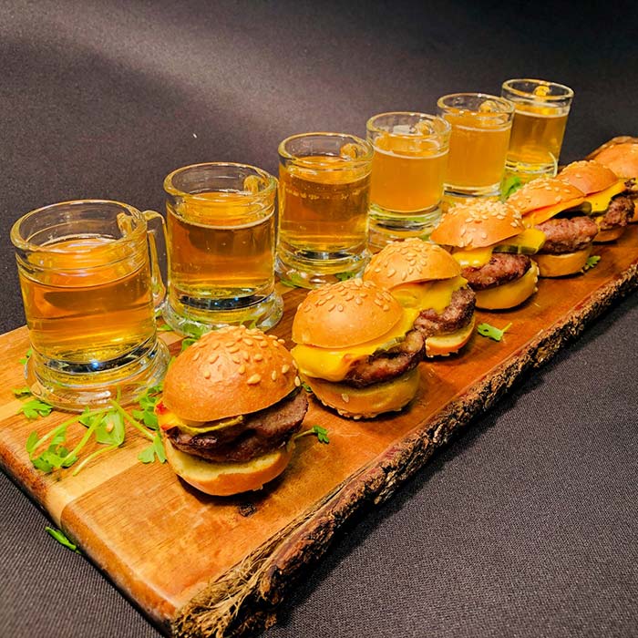 Mini sliders paired with craft beer shooters at Le Chateau Banquets reception station