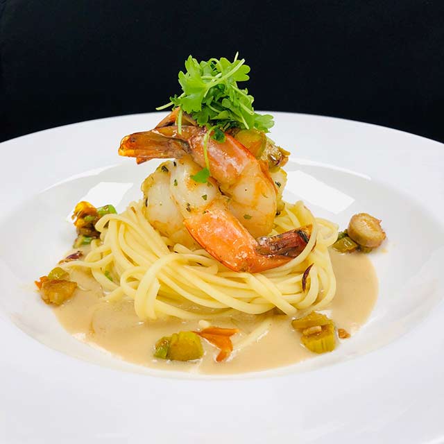Linguini fini with sautéed shrimp in a creamy garlic sauce and fresh herbs.