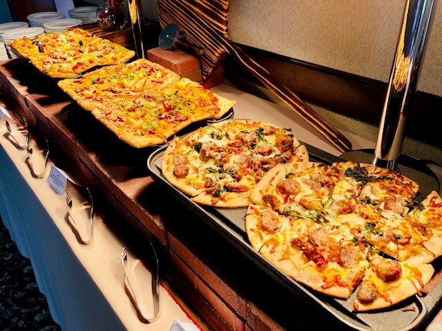 Flatbread station featuring assorted artisan pizzas for banquet and reception dining.