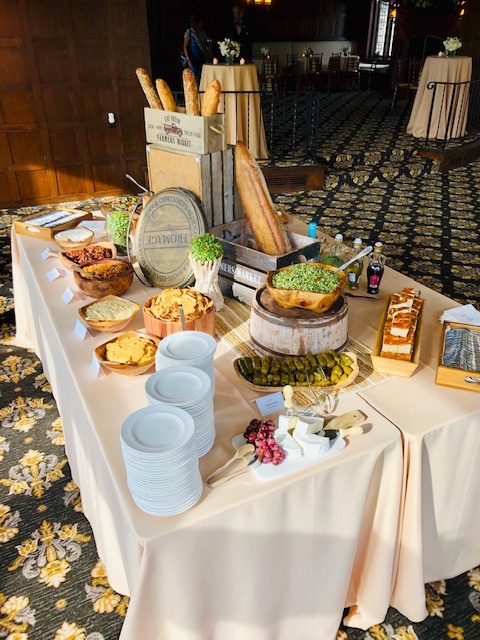 Mediterranean grazing table with artisan breads, cheeses, dips, and fresh appetizers.