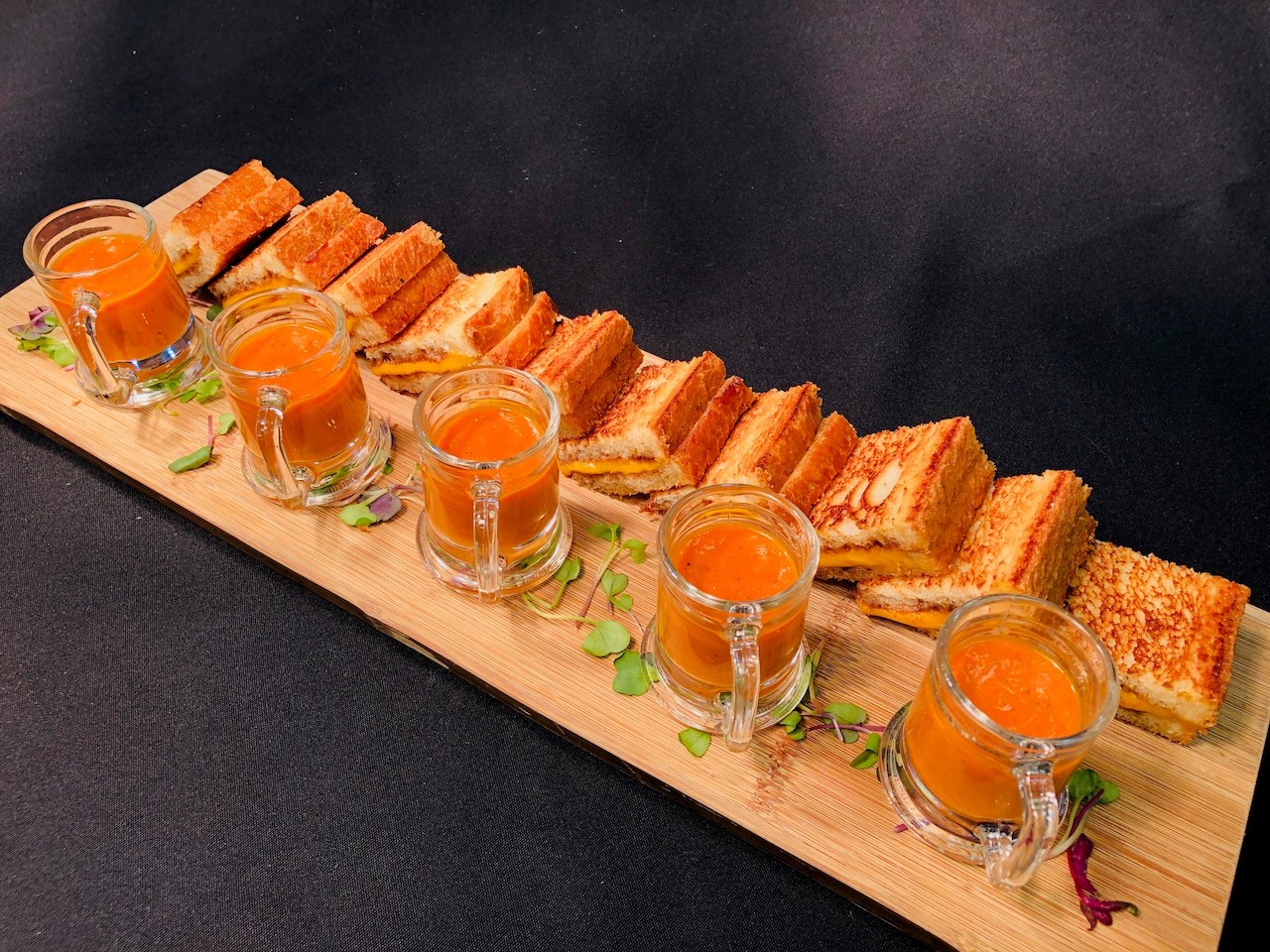 Mini grilled cheese sandwiches with tomato soup shooters and fruit chutney for cocktail hour events
