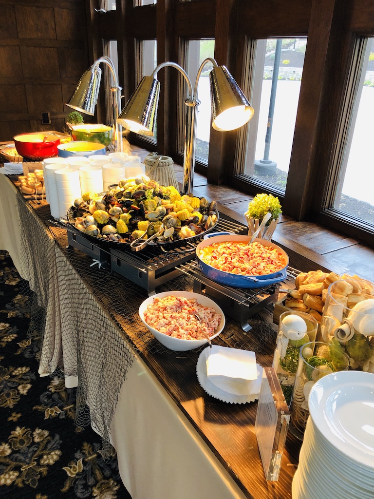 New England seafood station with lobster salad, clams, and coastal-inspired appetizers.