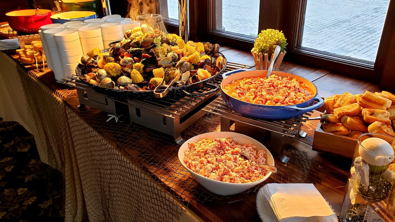 New England seafood station with lobster salad, shellfish, and fresh baked rolls.