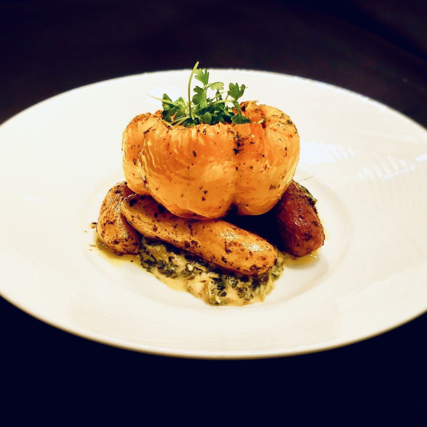 Wild rice stuffed pepper served with roasted potatoes and herb cream sauce.