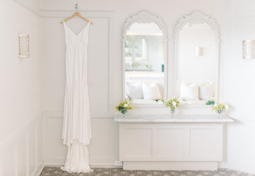 Elegant bridal suite with wedding dress and mirrored vanity at Le Chateau Banquets