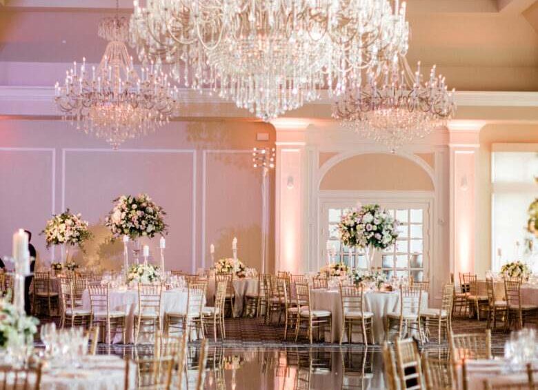 Elegant wedding reception ballroom with crystal chandeliers and floral centerpieces