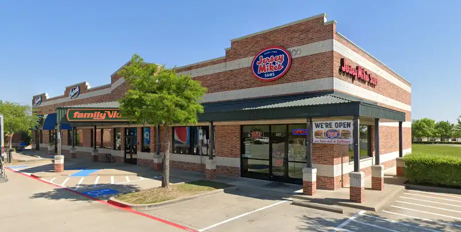 Exterior view of a shopping plaza featuring Family Video and Jamba Juice storefronts on a sunny day.