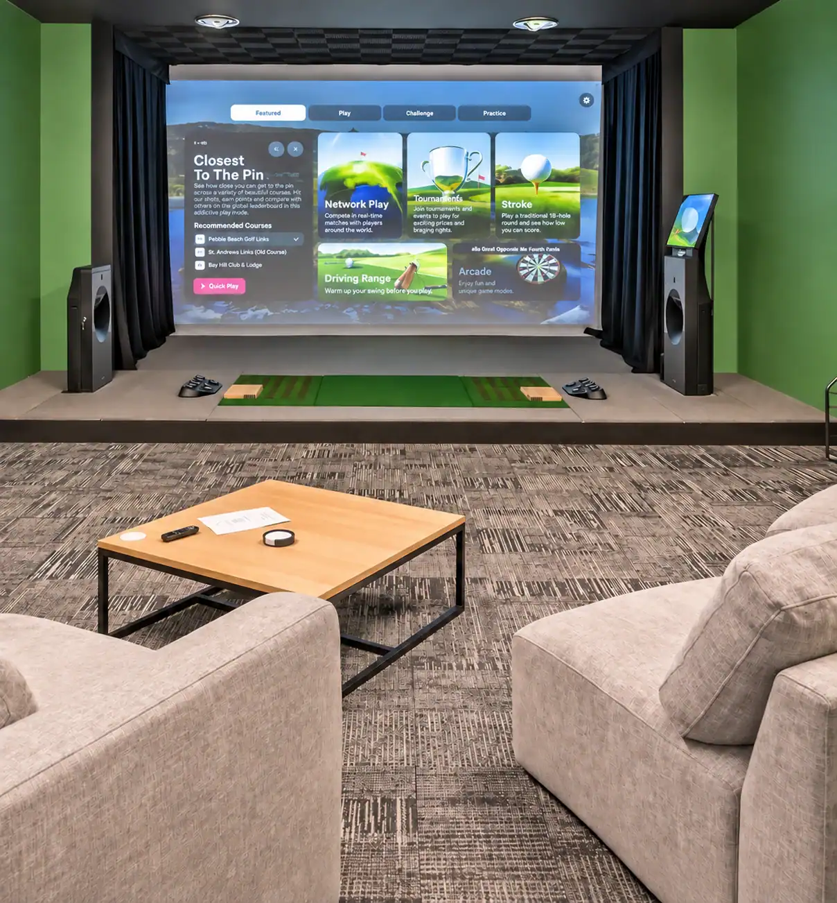 A home theater room with a large screen displaying a golf game, two speakers on each side, and a cozy seating area with a coffee table.