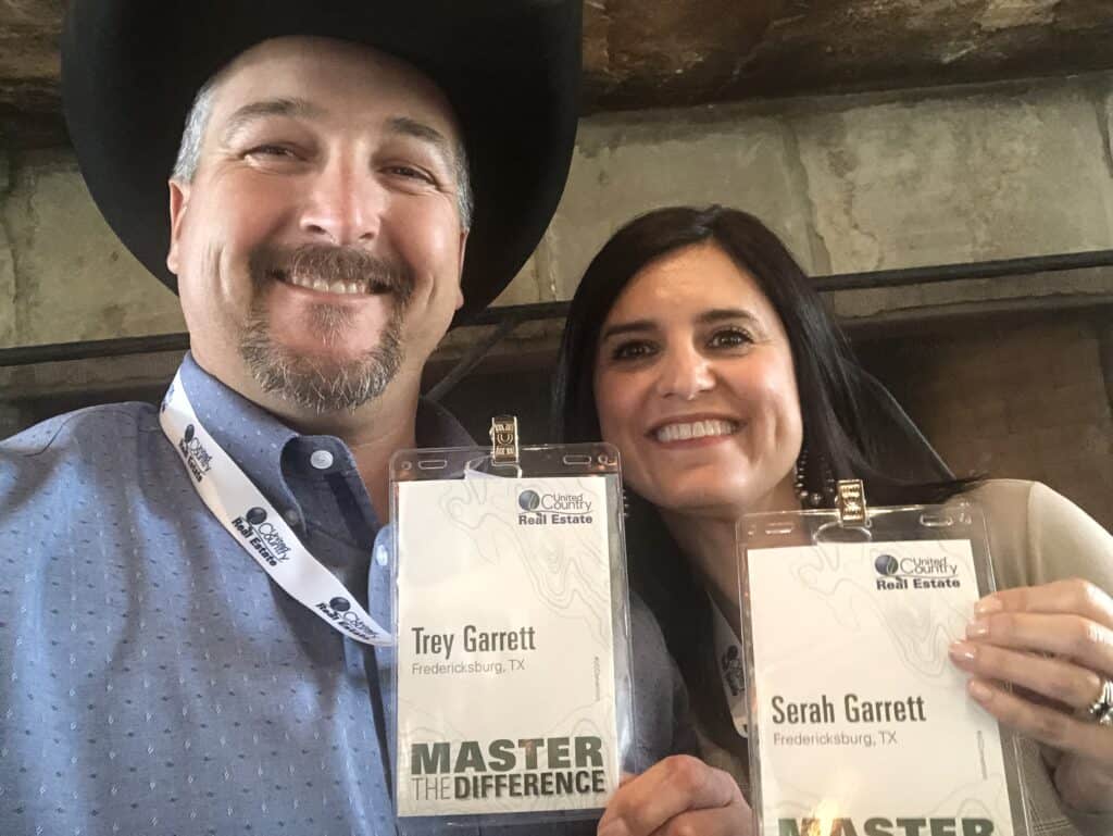 Garrett Realty & Auction team holding awards at event.