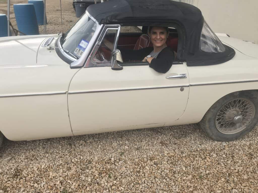 Classic white convertible car with a black soft top at Garrett Realty & Auction.