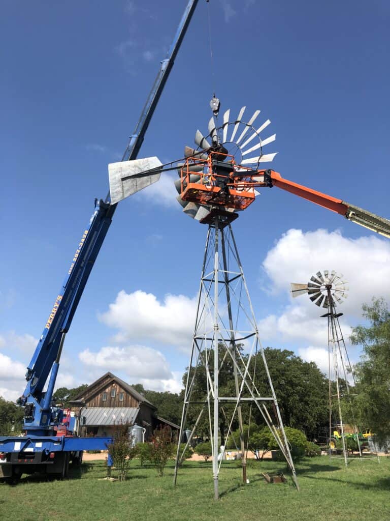 Windmill with blue sky and clouds in background.