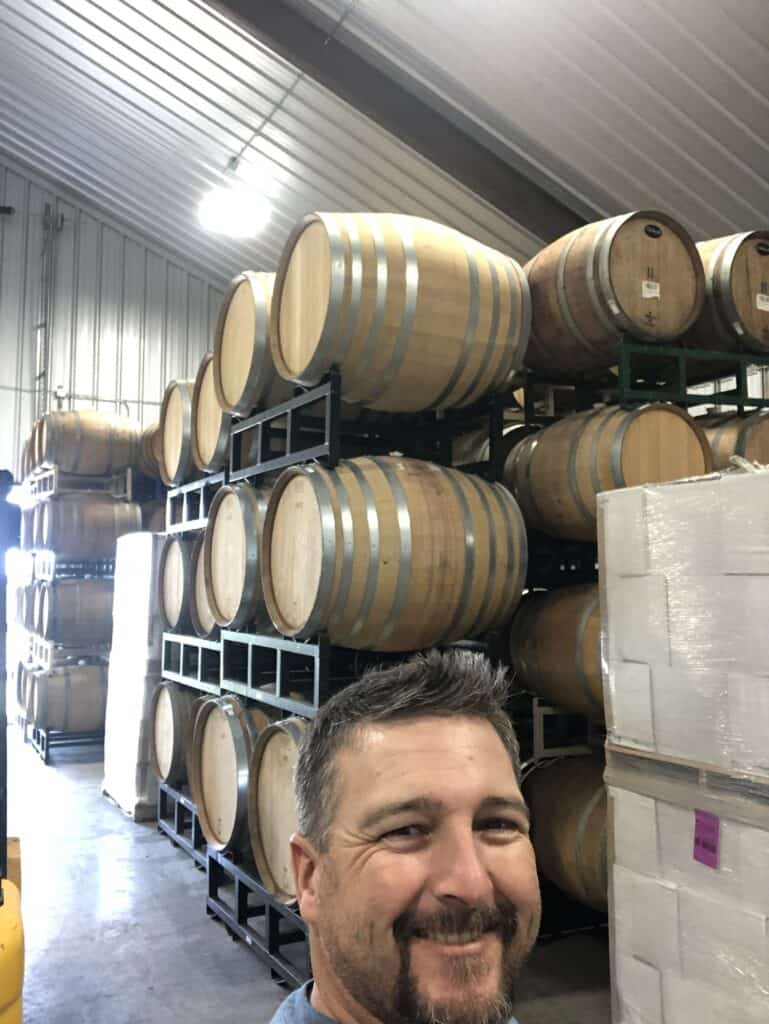 Interior of a wine barrel storage with stacked barrels at Garrett Realty & Auction.