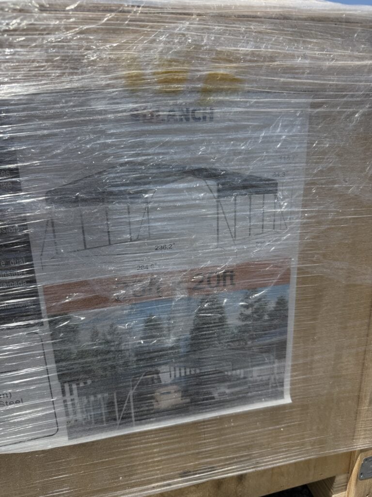 Garage sale auction flyer wrapped in plastic on wooden pallet.