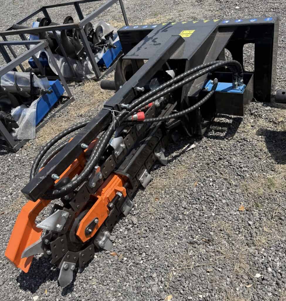 Heavy equipment attachment with hydraulic components for construction or industrial use.