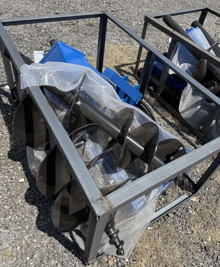 Snow blower in metal cart for auction at Garrett Realty & Auction.