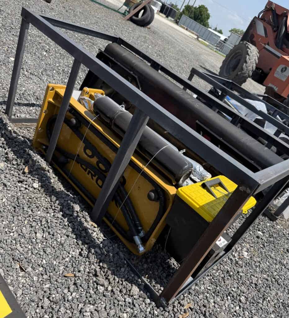 Hydraulic power unit inside a metal frame at Garrett Realty & Auction.