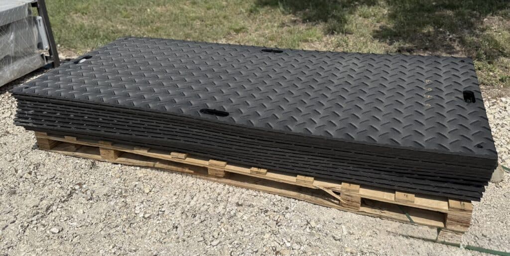 Garage door panels stacked on a pallet for auction at Garrett Realty & Auction.