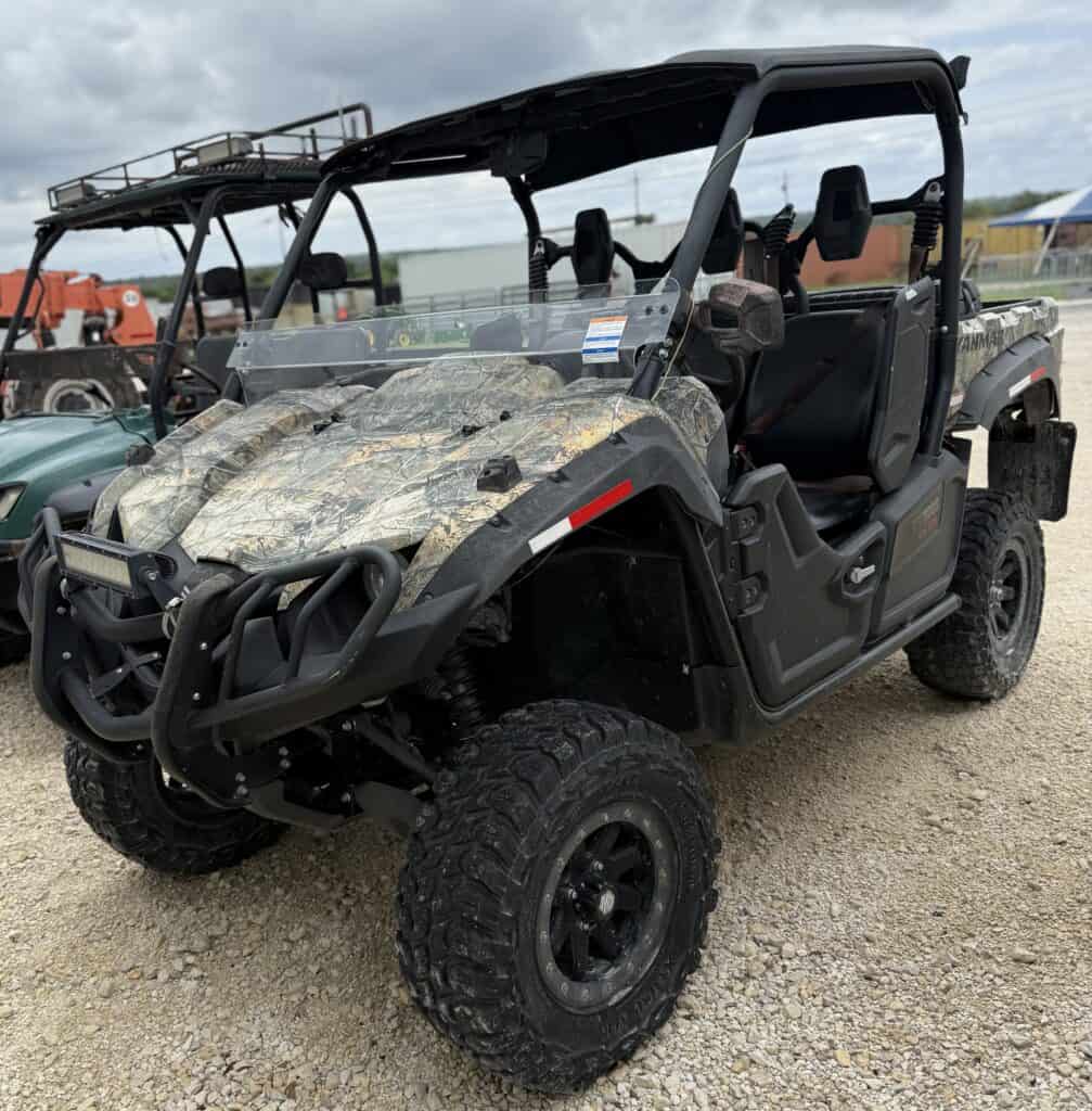 All-Terrain Utility Vehicle with rugged tires and camouflage design for outdoor work and recreation.