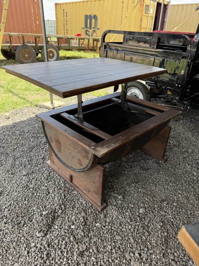 Vintage outdoor wooden table with metal base for auction.