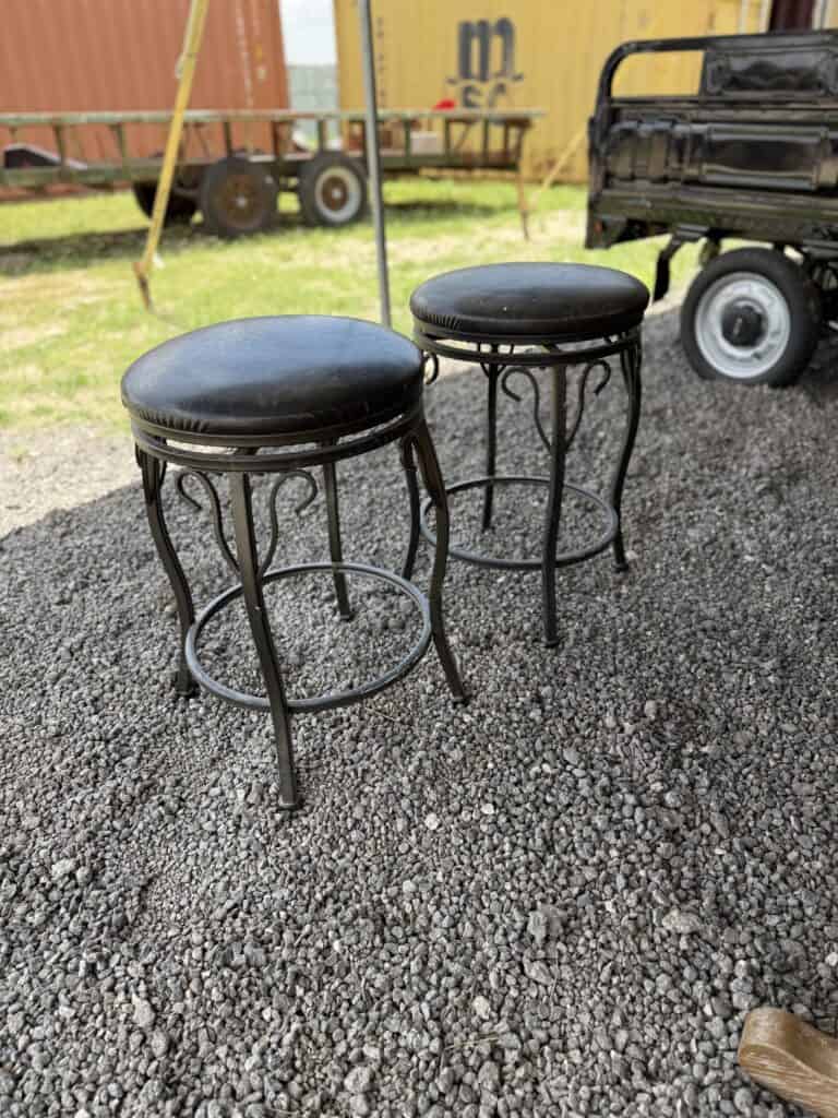 Vintage metal and leather bar stools for auction.