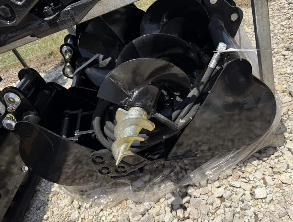Construction auger attachment for heavy machinery at auction.