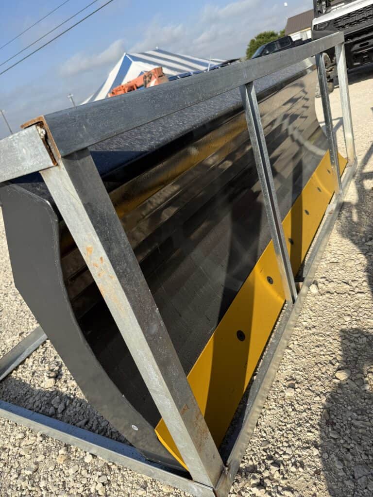 Steel and yellow safety barrier at equipment auction.