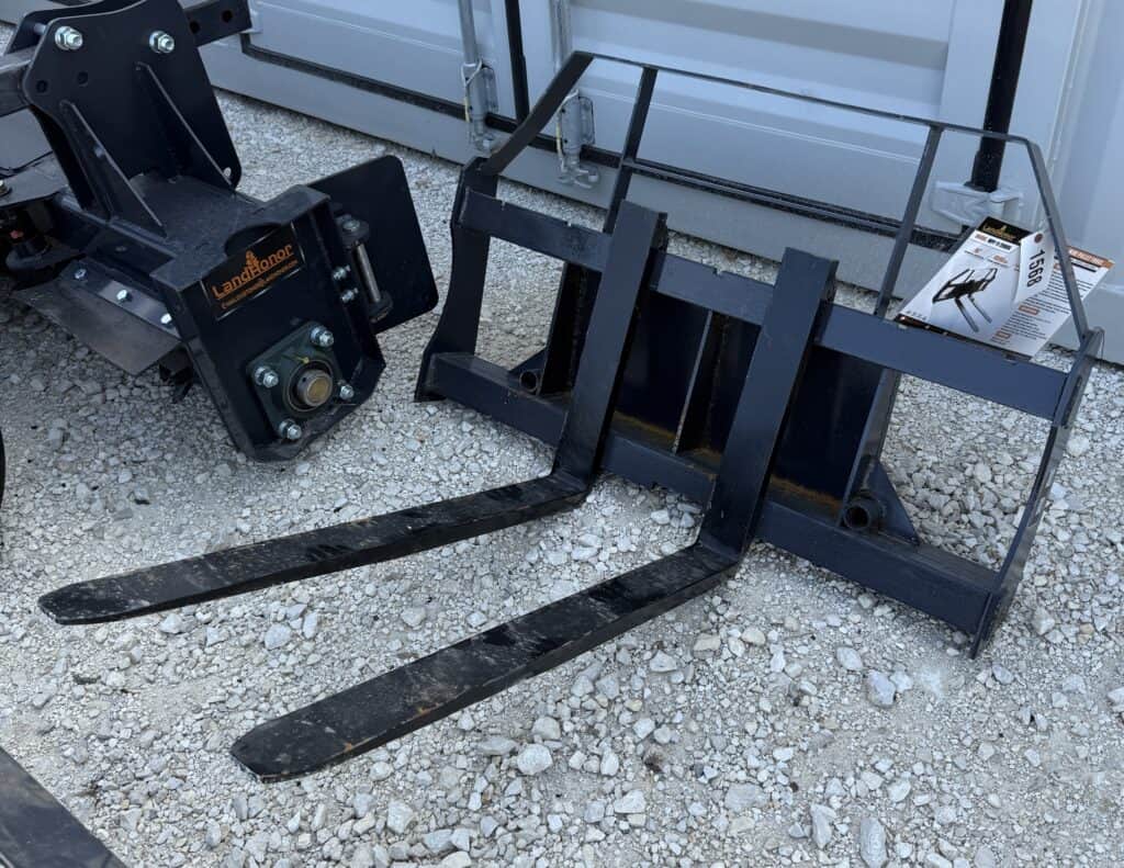 Heavy-duty forklift forks and attachment for auction at Garrett Realty & Auction.