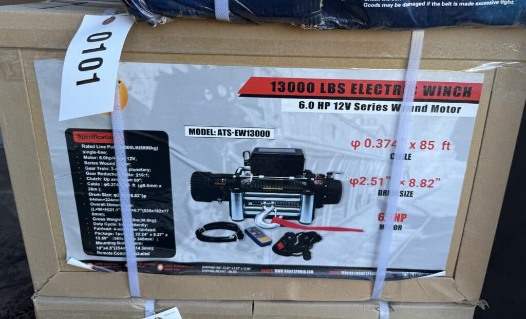 Heavy-duty 13000 lbs electric winch with 6 HP motor and remote control.