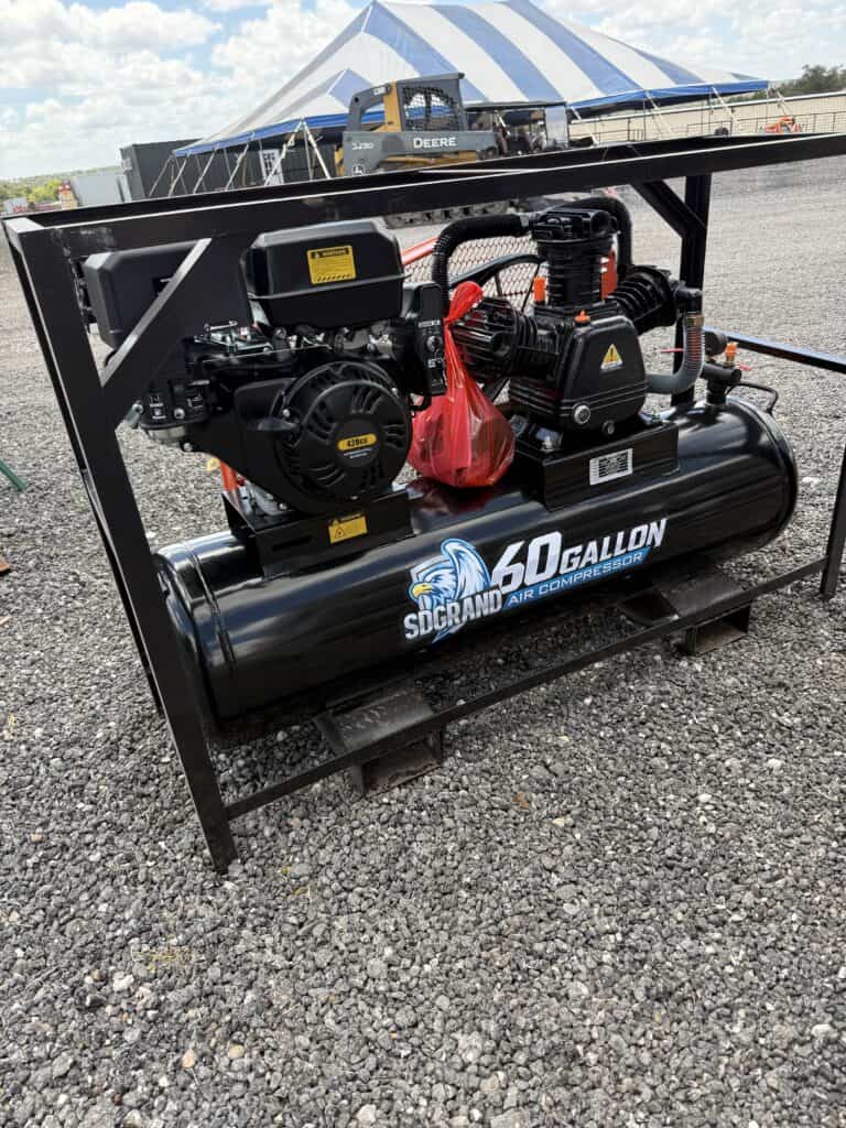 Industrial 60-gallon air compressor at Garrett Realty & Auction.