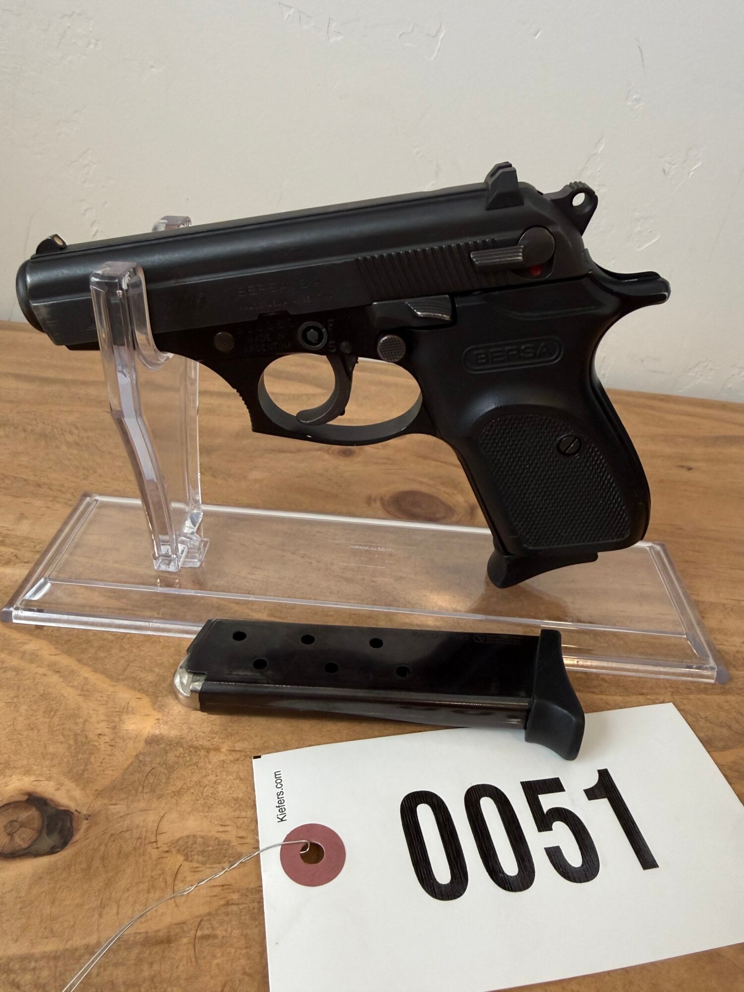 Black airsoft pistol with magazine on display at auction.