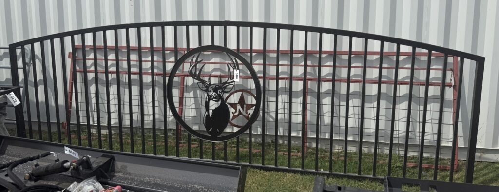 Decorative deer sign on black metal fence at October 3rd auction.