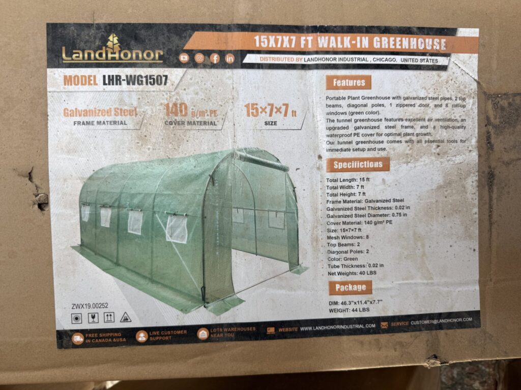 Portable greenhouse with 15x7x7 ft dimensions for gardening.